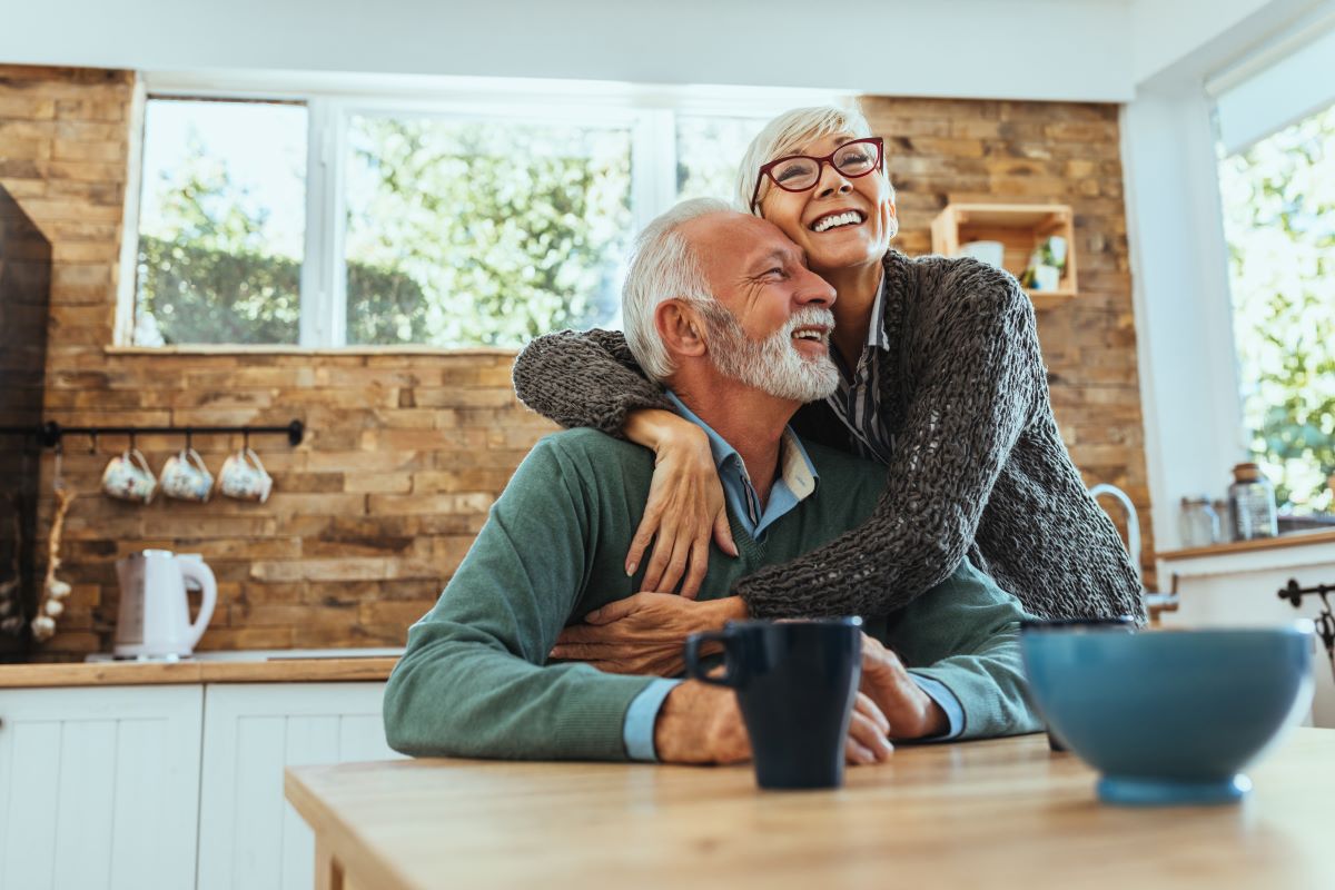 Old couple smiling and hugging
